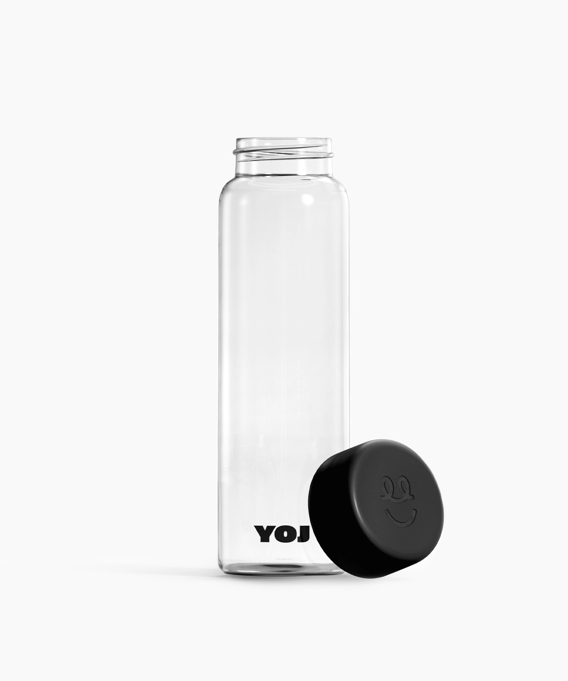 Flaska med svart lock ståendes på sidan